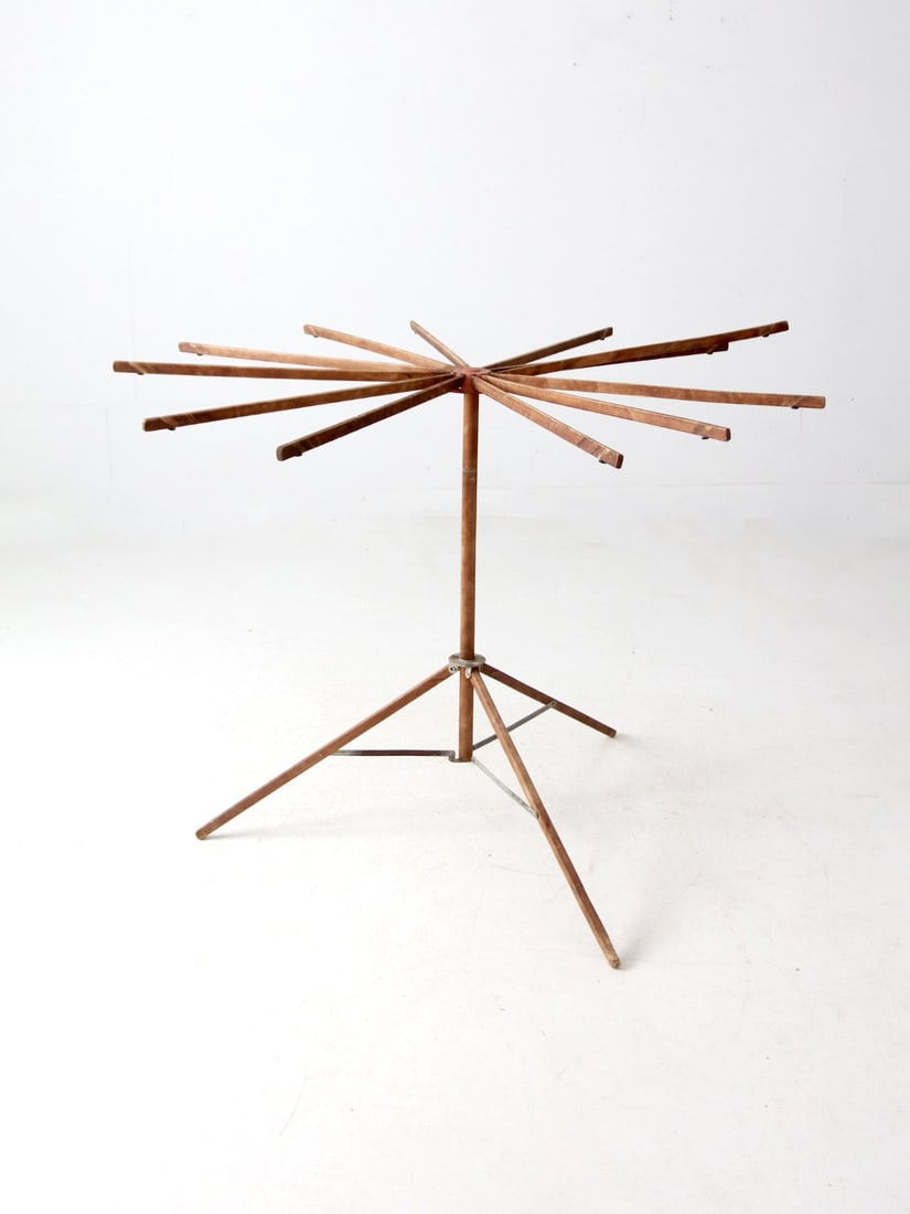 Early 20th Century Antique Folding Laundry Rack with Red Metal Top: Early 20th Century Antique Folding Laundry Rack with Red Metal Top This early 20th-century antique drying rack showcases a unique free-standing folding design, featuring trifold legs and a sturdy wood