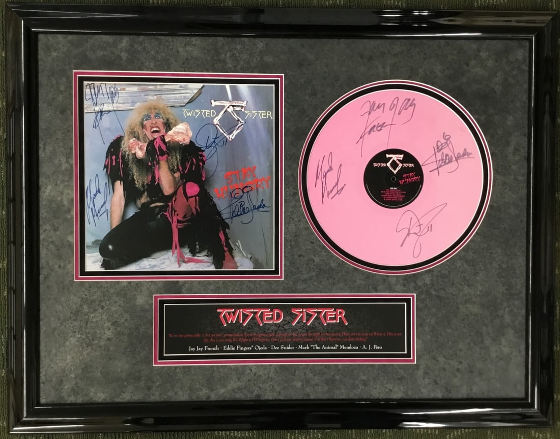 Twisted Sister Signed Pink Album Cover & Record Custom Framed with 8 Signatures: Twisted Sister Signed Pink Album Cover & Record Custom Framed with 8 Signatures This custom framed album cover features signatures from four iconic members of the Twisted Sister band, making it a must