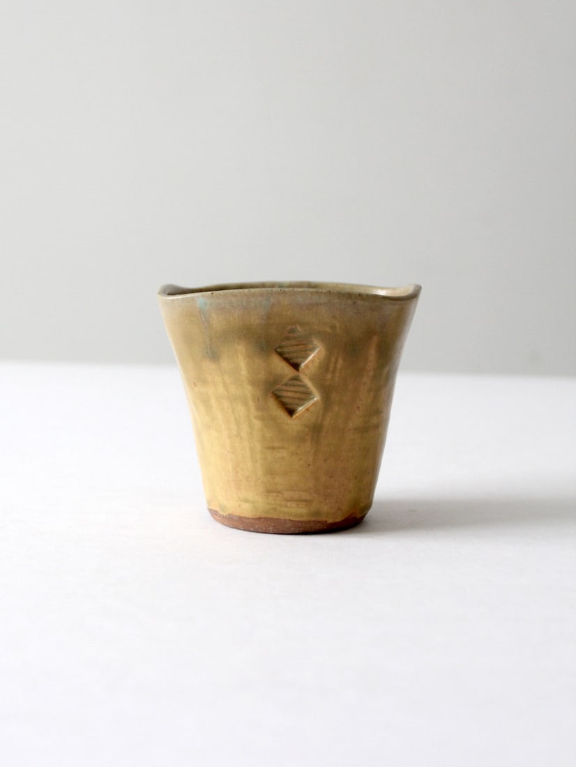 Handcrafted Vintage Studio Pottery Vase with Stamped Design: Handcrafted Vintage Studio Pottery Vase with Stamped Design Discover this unique vintage studio pottery vase, a stunning piece handcrafted by the artist. It features a distinctive stamped design adorn