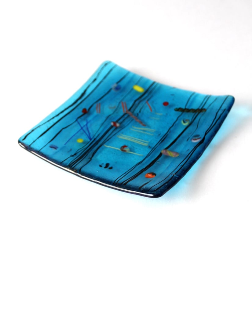 Mid Century Blue Fused Glass Tray with Geometric Accents: Mid Century Blue Fused Glass Tray with Geometric Accents Enhance your decor with this mid-century fused glass tray, featuring a vibrant blue hue accented by geometric bauble and stripe designs. This t