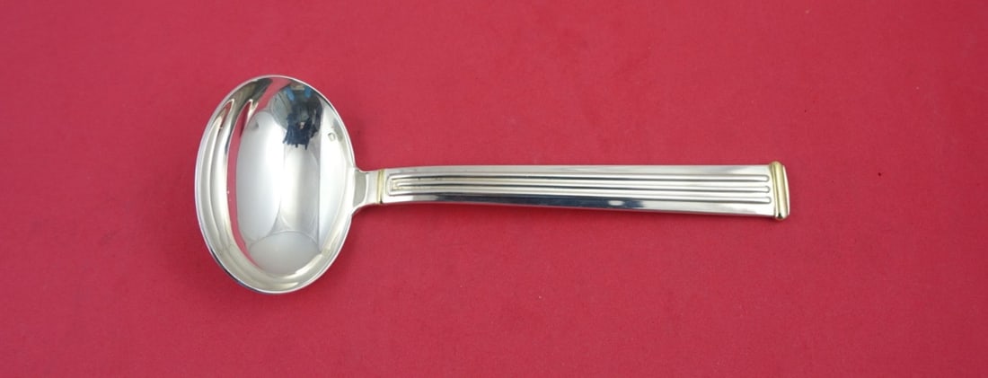 Christofle Triade Gold Accent Silverplate Gravy Ladle 7.25": Christofle Triade Gold Accent Silverplate Gravy Ladle 7.25" This elegant gravy ladle features the exquisite Triade Gold Accent pattern by Christofle, crafted from high-quality silverplate. Measuring 7