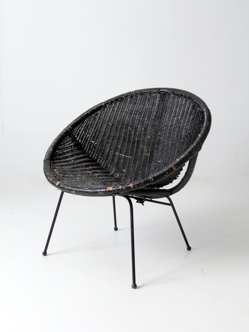 Mid Century Modern Black Wicker Satellite Chair by 86 Vintage: Mid Century Modern Black Wicker Satellite Chair by 86 Vintage Enhance your living space with this striking Mid Century Black Wicker Saucer Chair. Its minimalist chic design features a rounded seat cra