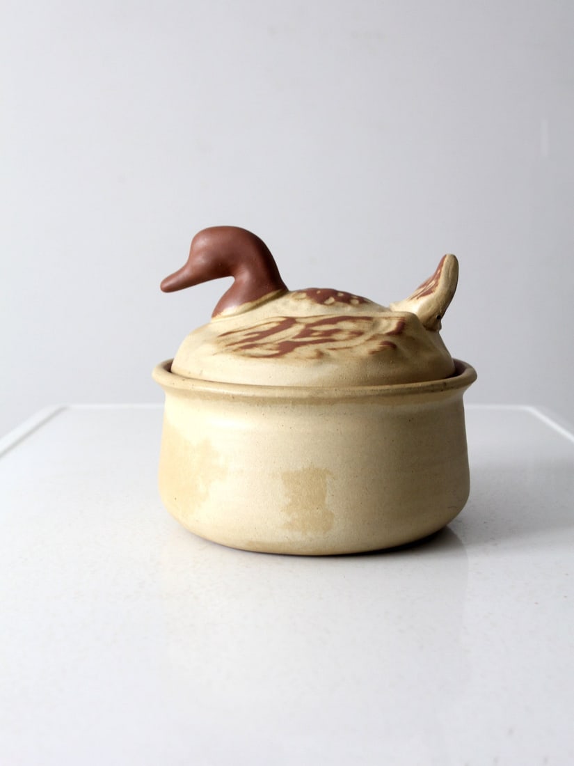 Mid-Century Vintage Duck-Shaped Covered Tureen 8.5": Mid-Century Vintage Duck-Shaped Covered Tureen 8.5" This mid-20th century vintage covered tureen combines style and functionality beautifully. Crafted from clay, it features a charming mallard duck-sh