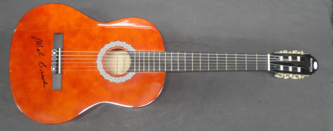 Mel Brooks Hand Signed Acoustic Guitar Authenticated by JSA: Mel Brooks Hand Signed Acoustic Guitar Authenticated by JSA This is a Mel Brooks hand-signed acoustic guitar, a true collector's item for fans of the legendary filmmaker and comedian. The guitar comes