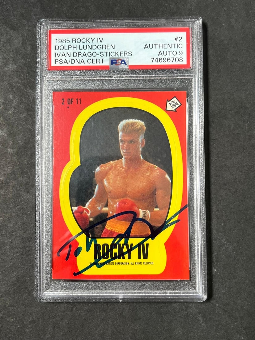 1985 Rocky IV Sticker Signed by Dolph Lundgren PSA/DNA Authentic: 1985 Rocky IV Sticker Signed by Dolph Lundgren PSA/DNA Authentic This is a 1985 Topps Rocky IV sticker featuring the iconic character Ivan Drago, signed by actor Dolph Lundgren. The autograph has been
