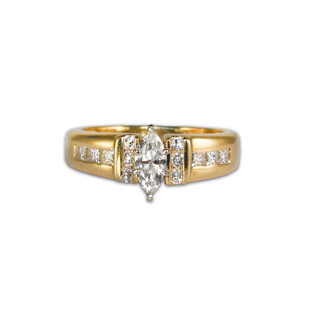 14K Yellow Gold Ladies Marquise Diamond Ring 1.00 ct VS I-J: 14K Yellow Gold Ladies Marquise Diamond Ring 1.00 ct VS I-J This exquisite ring features a stunning marquise diamond at its center, weighing 0.50 carats. The diamond exhibits a clarity grade of VS and