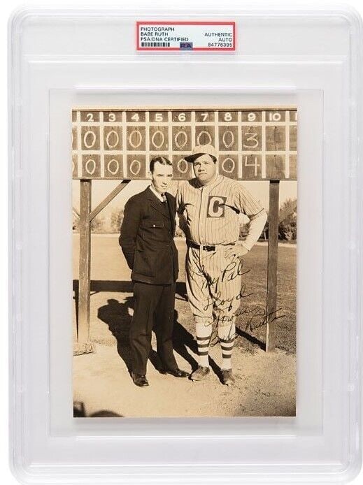 Babe Ruth Autographed Photo 6x8.5 Yankees PSA/DNA Inscribed: Babe Ruth Autographed Photo 6x8.5 Yankees PSA/DNA Inscribed This is a vintage glossy 6 x 8.5 photo of Babe Ruth, depicted in a barnstorming uniform with his cap tipped askew, standing alongside an ump