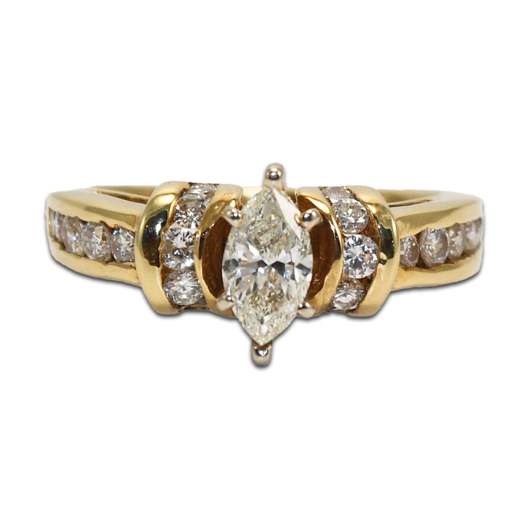 14K Yellow Gold Marquise Diamond Engagement Ring 0.98ct SI1 I Color: 14K Yellow Gold Marquise Diamond Engagement Ring 0.98ct SI1 I Color This stunning engagement ring features a beautifully crafted marquise diamond set in 14K yellow gold. The center diamond weighs 0.65