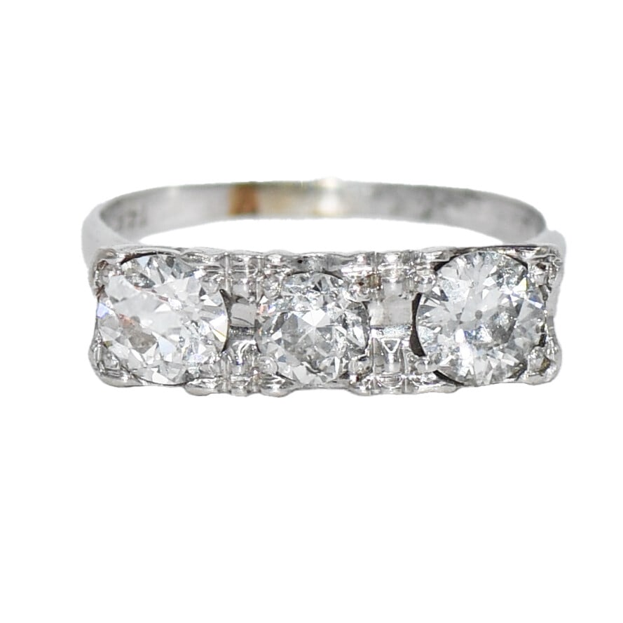 Vintage 14K White Gold Three-Stone Diamond Ring 1.05cts H-I SI1-SI2 Size 5.75: Vintage 14K White Gold Three-Stone Diamond Ring 1.05cts H-I SI1-SI2 Size 5.75 This vintage three-stone diamond ring is elegantly crafted in 14K white gold, showcasing a stunning array of diamonds tota