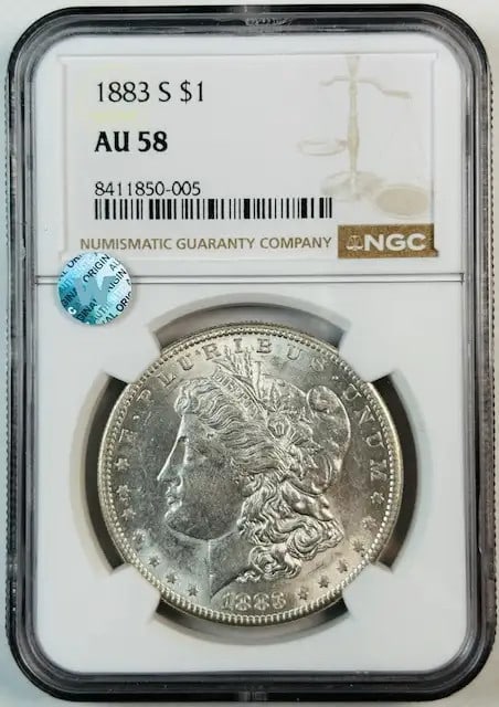 NGC AU 58 1883 San Francisco Morgan Silver Dollar Coin: NGC AU 58 1883 San Francisco Morgan Silver Dollar Coin This is an 1883 Morgan Silver Dollar graded AU-58 by NGC. Minted in San Francisco, this circulated coin is composed of silver and features a brig