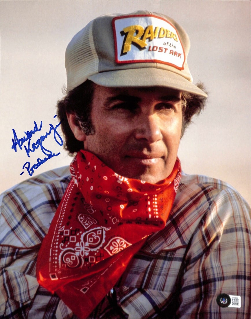 Howard Kazanjian Signed 11x14 Indiana Jones Photograph Beckett Authenticated: Howard Kazanjian Signed 11x14 Indiana Jones Photograph Beckett Authenticated This autographed 11x14 color photograph features Howard Kazanjian, the producer of "Indiana Jones: Raiders of the Lost Ark.