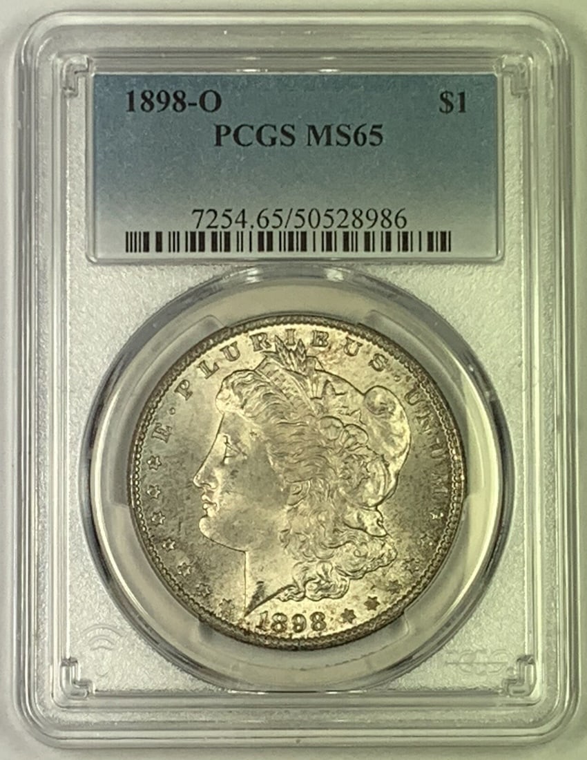 1898-O Morgan Silver Dollar PCGS MS 65 Uncirculated Silver Coin: 1898-O Morgan Silver Dollar PCGS MS 65 Uncirculated Silver Coin This exquisite 1898-O Morgan Silver Dollar showcases a beautiful toning and is graded as MS 65 by PCGS, ensuring its exceptional quality