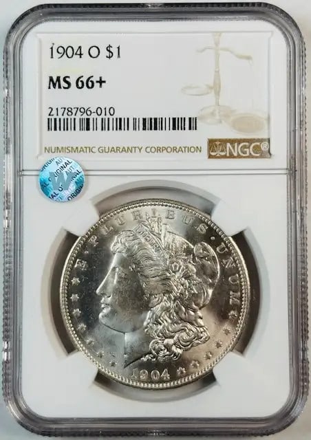 1904 O Morgan Silver Dollar NGC MS66+ Uncirculated Coin: 1904 O Morgan Silver Dollar NGC MS66+ Uncirculated Coin This 1904 O Morgan Silver Dollar is a stunning piece certified by NGC with a high grade of MS 66+. The coin showcases a brilliant white appearan