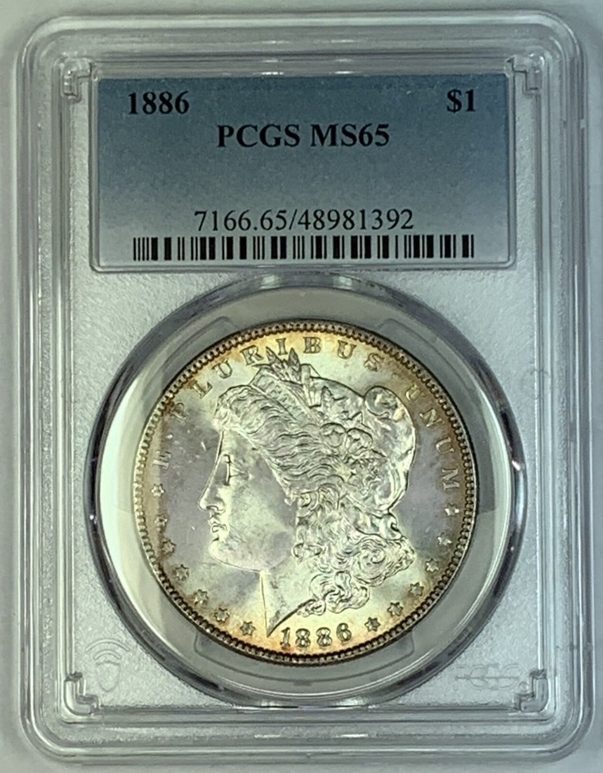1886 Morgan Silver Dollar Coin PCGS MS 65 Uncirculated: 1886 Morgan Silver Dollar Coin PCGS MS 65 Uncirculated This 1886 Morgan Silver Dollar Coin is a remarkable addition for any collector. Graded MS 65 by PCGS, this uncirculated coin showcases the exquis