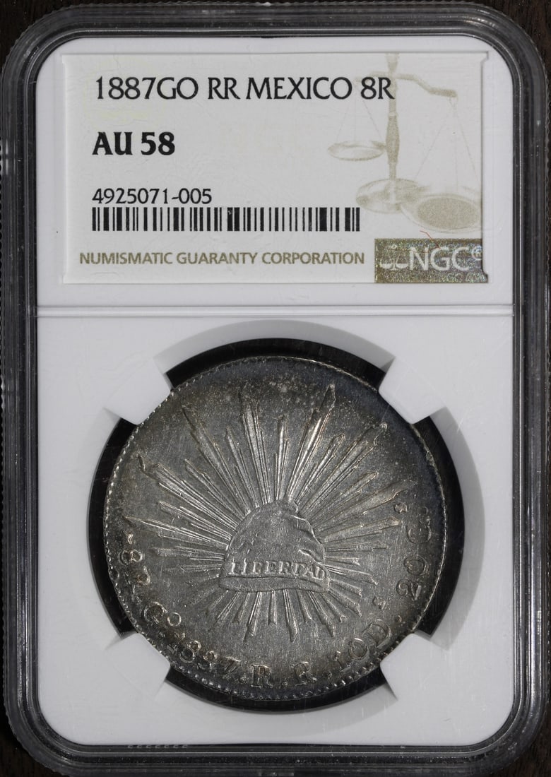 1887 Mexico Cap & Rays 8 Reales Coin NGC AU58 Rainbow Rim Tone: 1887 Mexico Cap & Rays 8 Reales Coin NGC AU58 Rainbow Rim Tone This stunning 1887 Go RR 8 Reales coin showcases a beautiful rainbow rim tone and is graded as AU 58 by NGC. It is composed of silver wit