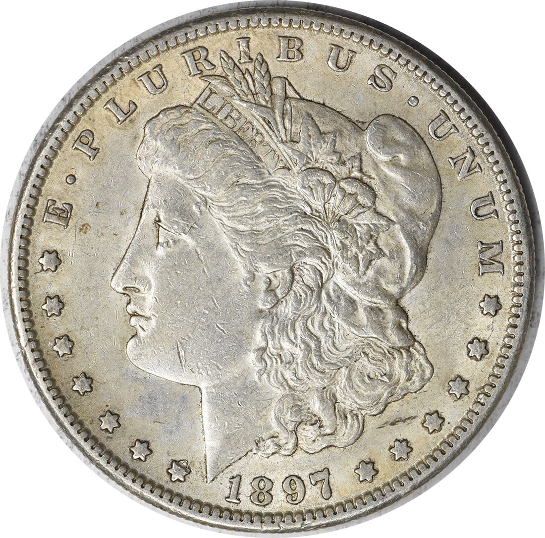 1897-S Morgan Silver Dollar AU Uncertified San Francisco Mint: 1897-S Morgan Silver Dollar AU Uncertified San Francisco Mint This 1897-S Morgan Silver Dollar is a stunning piece of numismatic history, featuring a design by George T. Morgan. It is an AU (About Unc