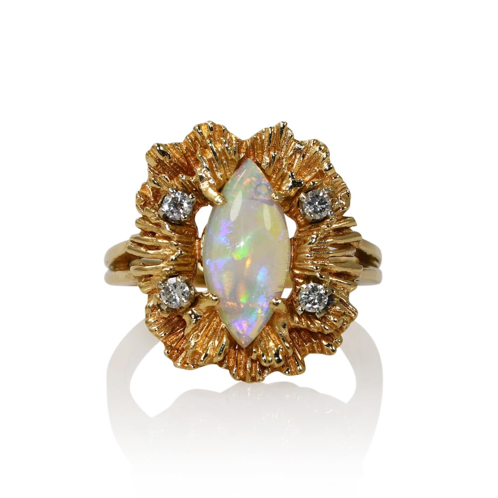 14K Yellow Gold Marquise Opal and Diamond Ring: 14K Yellow Gold Marquise Opal and Diamond Ring This exquisite ring features a stunning Australian opal set in a luxurious 14K yellow gold setting. The main stone is a marquise-shaped crystal opal, mea