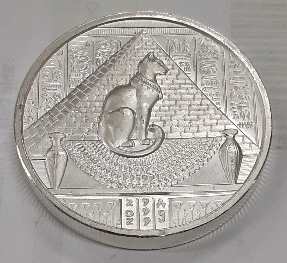 Bastet Design 2 Ounce .999 Fine Silver Round Ancient Egypt Coin: Bastet Design 2 Ounce .999 Fine Silver Round Ancient Egypt Coin This exquisite 2-ounce round features the Bastet design, a tribute to the ancient Egyptian goddess. Crafted from .999 fine silver, this