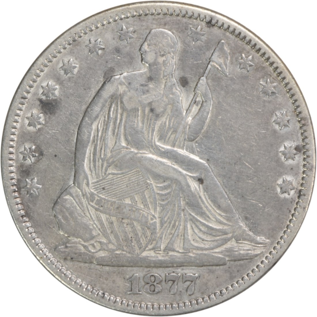 1877 Liberty Seated Half Dollar 50C VF Uncertified Silver Coin: 1877 Liberty Seated Half Dollar 50C VF Uncertified Silver Coin This 1877 Liberty Seated Silver Half Dollar is an exquisite piece of numismatic history. Graded as Very Fine (VF), this coin features the