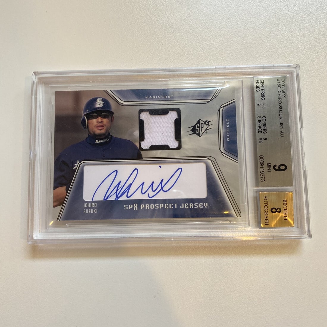 2001 Upper Deck SPx Ichiro Suzuki Rookie Card BGS 9 Game Used Jersey: 2001 Upper Deck SPx Ichiro Suzuki Rookie Card BGS 9 Game Used Jersey This remarkable 2001 Upper Deck SPx Ichiro Suzuki Rookie Card #150 features game-used jersey material and has been graded a BGS 9 M