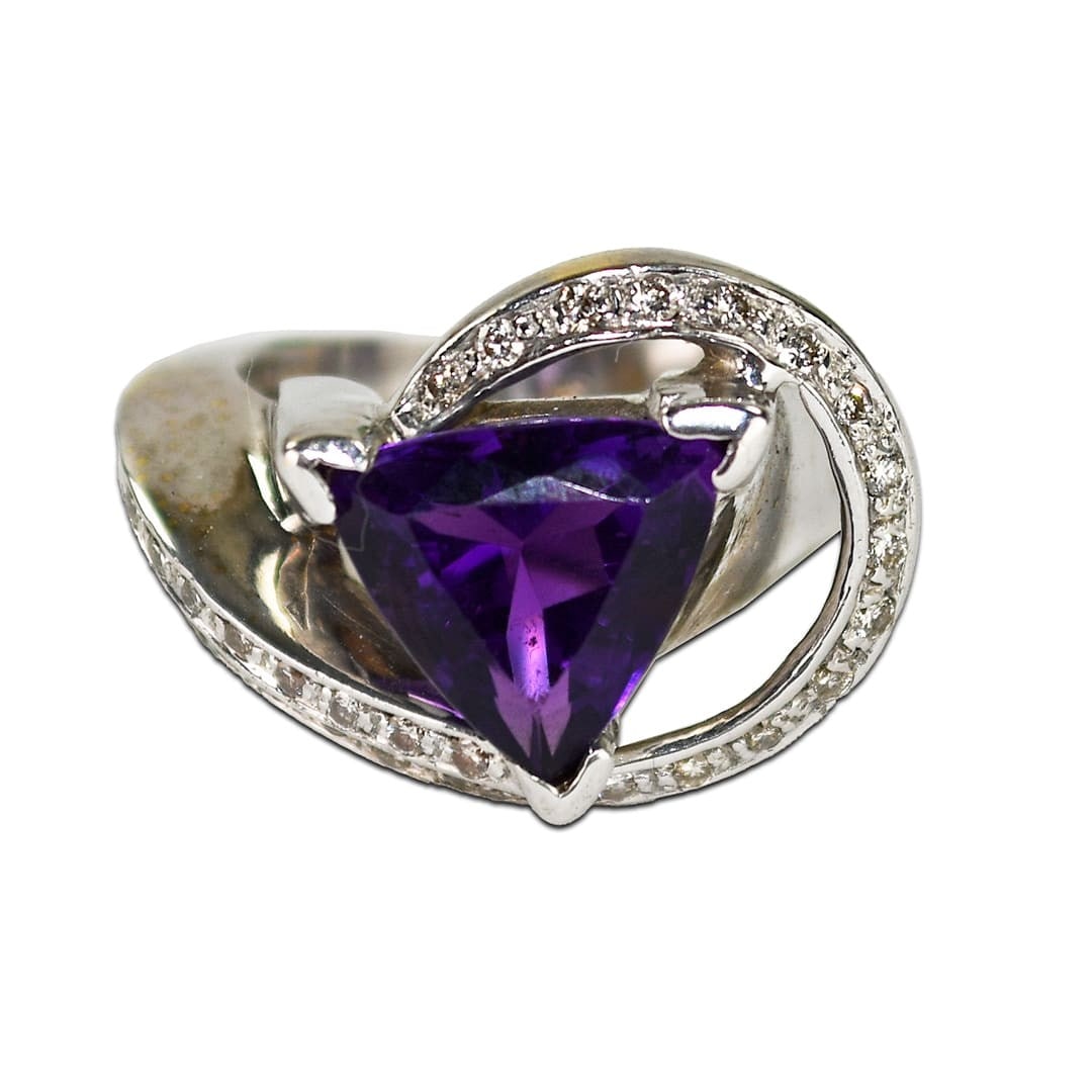 14K White Gold Amethyst Triangle Cocktail Ring with Diamonds: 14K White Gold Amethyst Triangle Cocktail Ring with Diamonds This exquisite cocktail ring features a stunning 4.50-carat triangular-shaped natural amethyst in a 14K white gold setting. The amethyst di