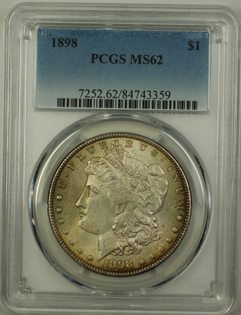 1898 Morgan Silver Dollar $1 PCGS MS62 Uncirculated Toned Coin: 1898 Morgan Silver Dollar $1 PCGS MS62 Uncirculated Toned Coin This 1898 Morgan Silver Dollar is a stunning example of coinage from the Philadelphia mint. Graded MS 62 by PCGS, this uncirculated coin