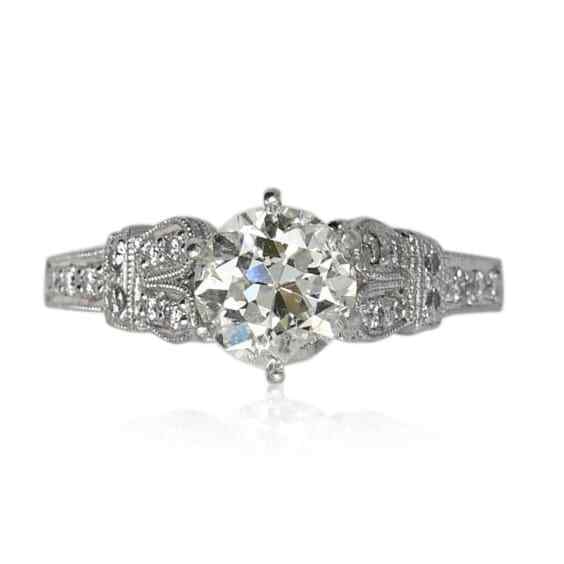 Vintage Platinum Ring 1.22ct Old Euro Cut Diamond with Scroll Work: Vintage Platinum Ring 1.22ct Old Euro Cut Diamond with Scroll Work This exquisite vintage platinum ring features a stunning 1.22 ct old-euro cut diamond at its center, showcasing a K color and SI3 to