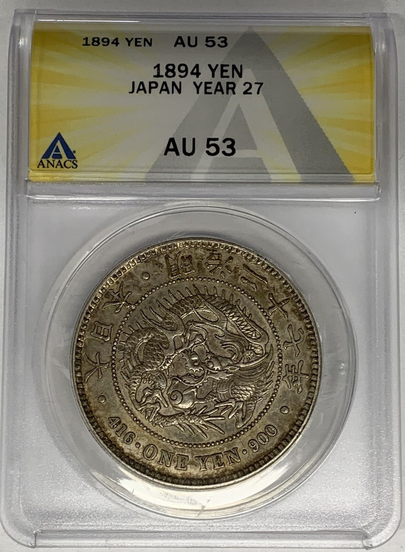 1894 Japan One Yen Coin Silver ANACS AU 53 Year 27: 1894 Japan One Yen Coin Silver ANACS AU 53 Year 27 This 1894 Japan One Yen Coin is a remarkable piece of history, showcasing a beautiful silver composition. Graded AU 53 by ANACS, this coin reflects i