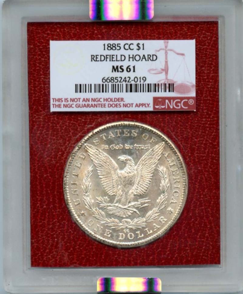 1885-CC Morgan Silver Dollar NGC MS61 Uncirculated Redfield Hoard: 1885-CC Morgan Silver Dollar NGC MS61 Uncirculated Redfield Hoard This 1885-CC Morgan Silver Dollar is a remarkable piece from the Redfield Hoard, certified by NGC with a grade of MS61. Struck in Cars