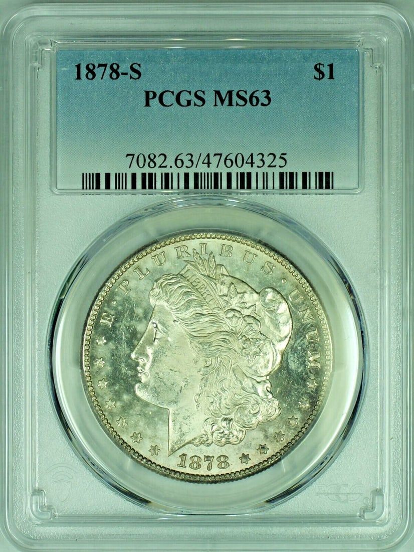 1878-S Morgan Silver Dollar Proof-Like PCGS MS 63: 1878-S Morgan Silver Dollar Proof-Like PCGS MS 63 This 1878-S Morgan Silver Dollar is a striking example of American coinage, featuring a semi-proof-like finish that enhances its intricate details. Ce