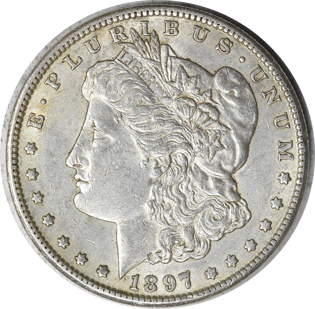 1897-S Morgan Silver Dollar AU Uncertified by George T. Morgan: 1897-S Morgan Silver Dollar AU Uncertified by George T. Morgan This 1897-S Morgan Silver Dollar is a captivating piece of American numismatic history. Struck in 90% silver and 10% copper, this coin ha