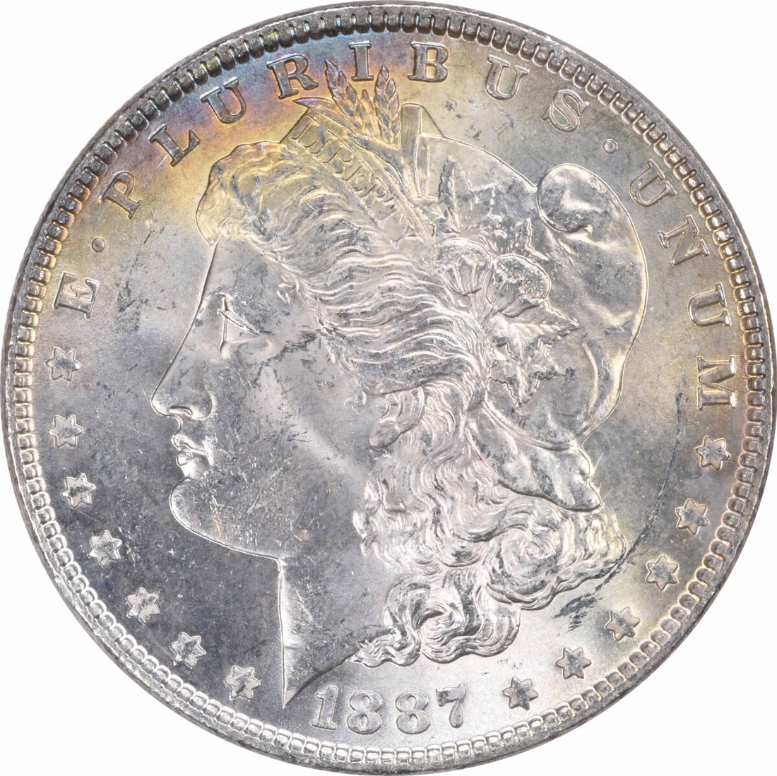 1887 Morgan Silver Dollar Choice BU Uncertified Silver Coin: 1887 Morgan Silver Dollar Choice BU Uncertified Silver Coin This 1887 Morgan Silver Dollar is a stunning example of American coinage, featuring a beautiful toning that adds to its aesthetic appeal. Gr