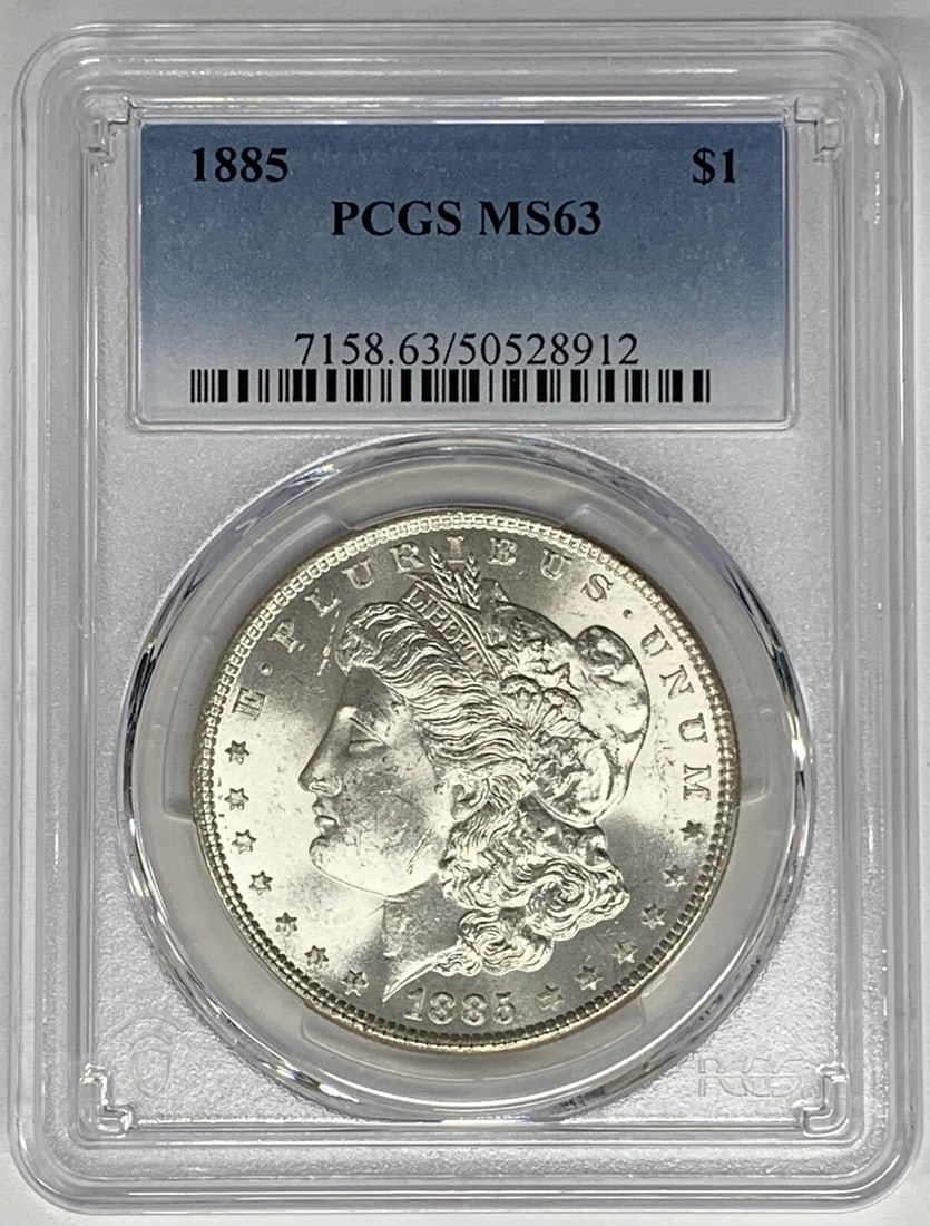 1885 Morgan Silver Dollar PCGS MS 63 Uncirculated Silver Coin: 1885 Morgan Silver Dollar PCGS MS 63 Uncirculated Silver Coin This 1885 Morgan Silver Dollar is a stunning example of American coinage. Graded MS 63 by PCGS, it is in uncirculated condition, showcasin