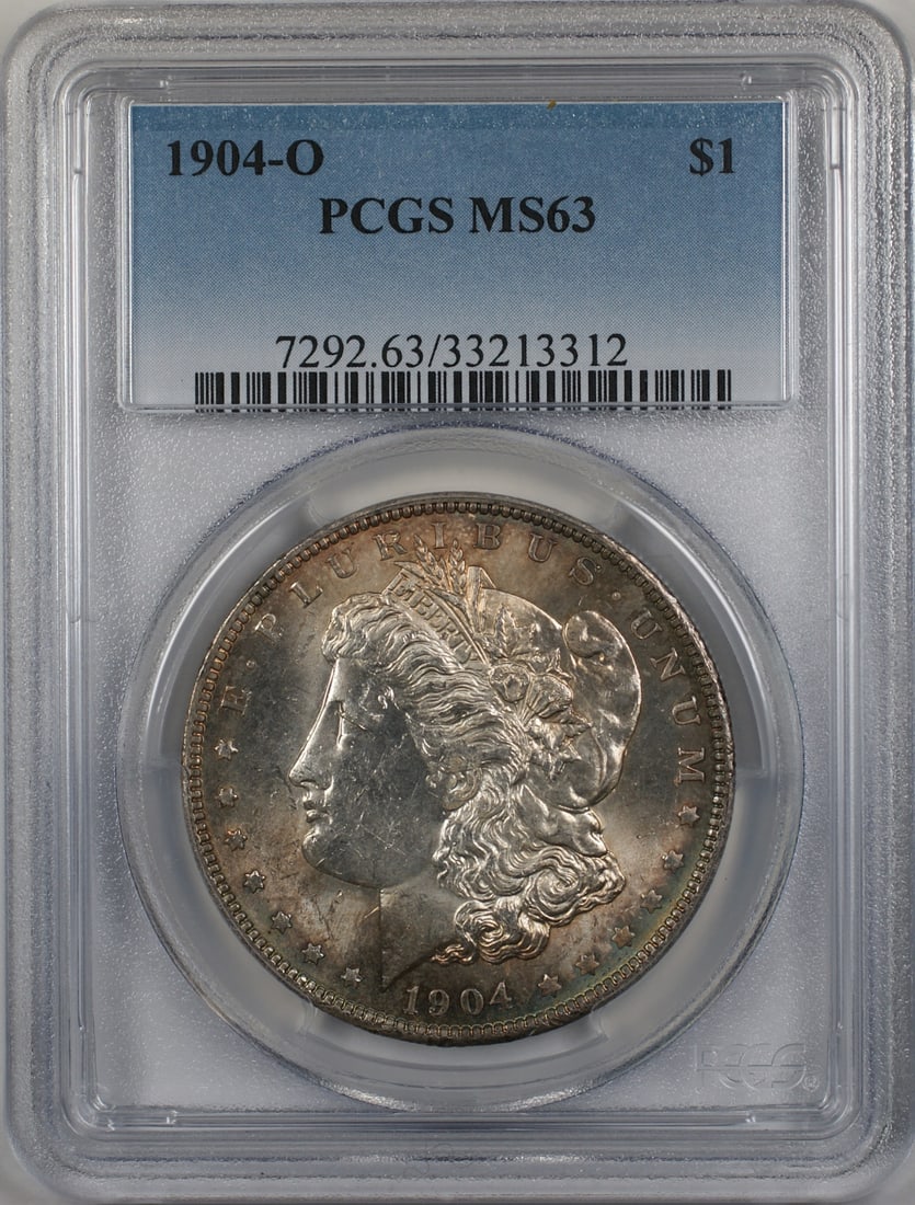 1904-O Morgan Silver Dollar Coin PCGS MS 63 Toned: 1904-O Morgan Silver Dollar Coin PCGS MS 63 Toned This 1904-O Morgan Silver Dollar is a stunning piece, certified by PCGS with a grade of MS 63. Struck in silver, this uncirculated coin showcases the