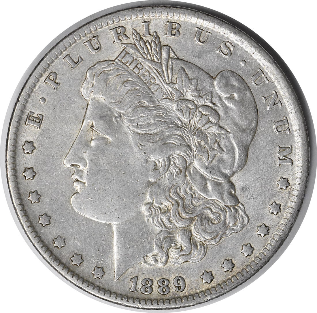 1889-O Morgan Silver Dollar AU Uncertified 90% Silver Coin: 1889-O Morgan Silver Dollar AU Uncertified 90% Silver Coin This 1889-O Morgan Silver Dollar showcases the artistry of designer George T. Morgan. Struck in New Orleans, this coin features a composition