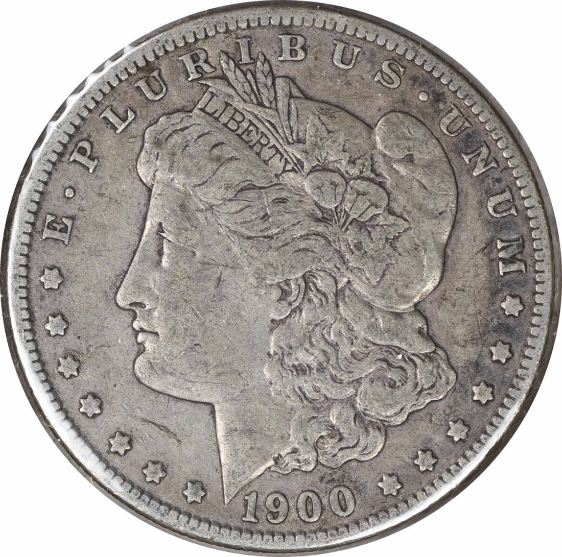 1900-O Morgan Silver Dollar VF Uncertified 90% Silver New Orleans Mint: 1900-O Morgan Silver Dollar VF Uncertified 90% Silver New Orleans Mint This 1900-O/CC Morgan Silver Dollar is a sought-after collectible coin, featuring a design by George T. Morgan. Crafted with a co