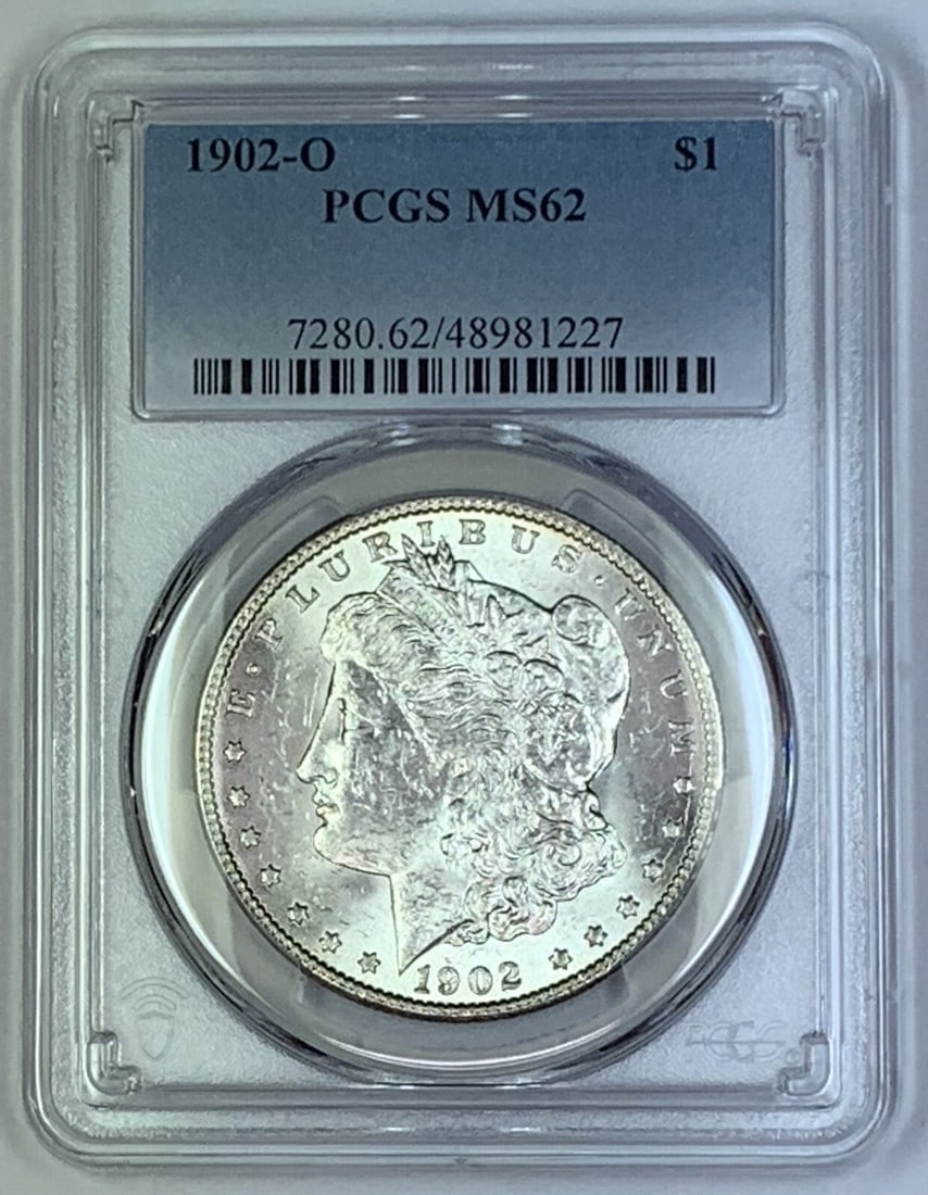 1902-O Morgan Silver Dollar Coin PCGS MS 62 Uncirculated: 1902-O Morgan Silver Dollar Coin PCGS MS 62 Uncirculated This stunning 1902-O Morgan Silver Dollar Coin is certified by PCGS with a grade of MS 62, reflecting its uncirculated condition. The coin feat