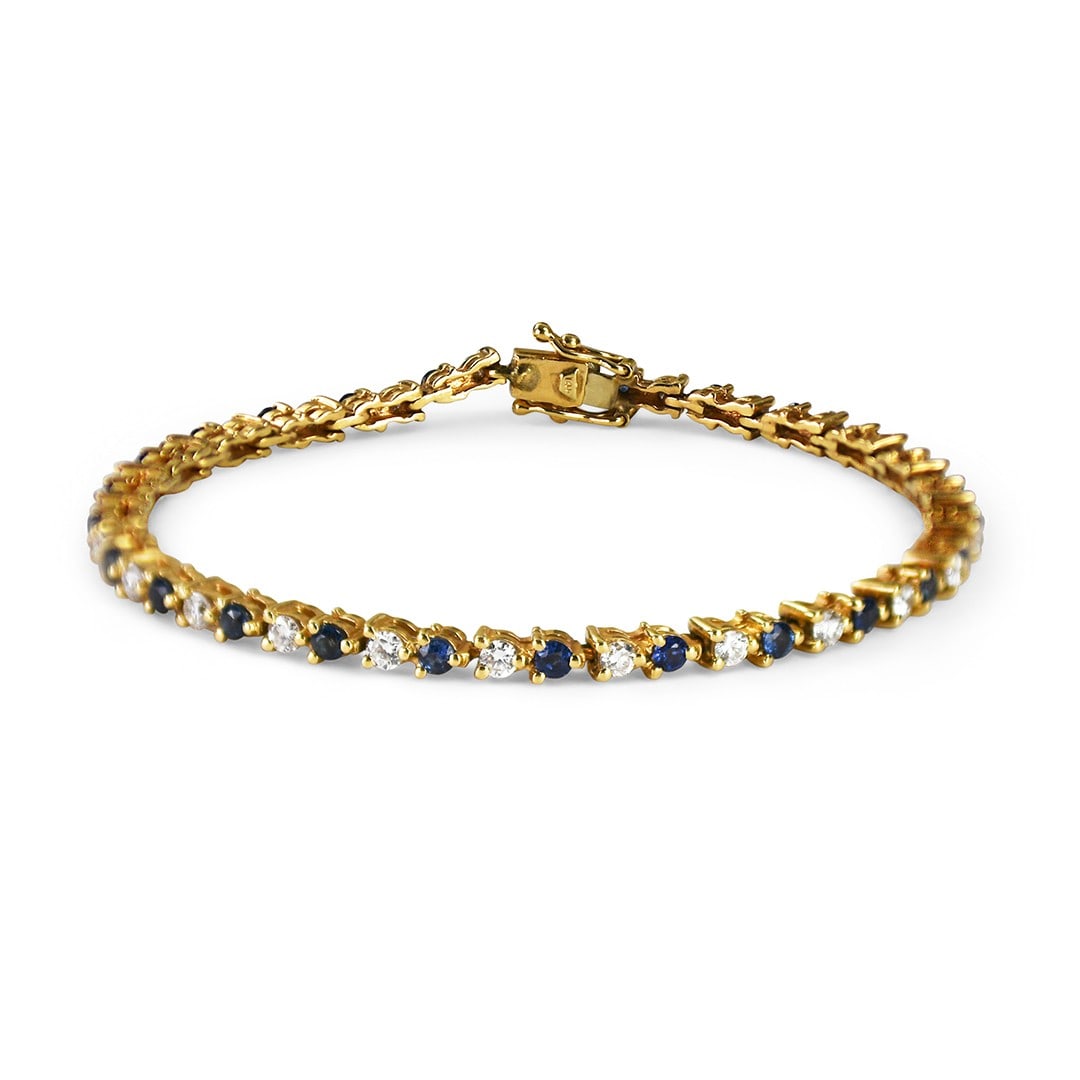 14K Yellow Gold Tennis Bracelet with Diamonds and Sapphires: 14K Yellow Gold Tennis Bracelet with Diamonds and Sapphires This stunning tennis bracelet features a beautiful combination of diamonds and blue sapphires set in luxurious 14K yellow gold. The bracelet