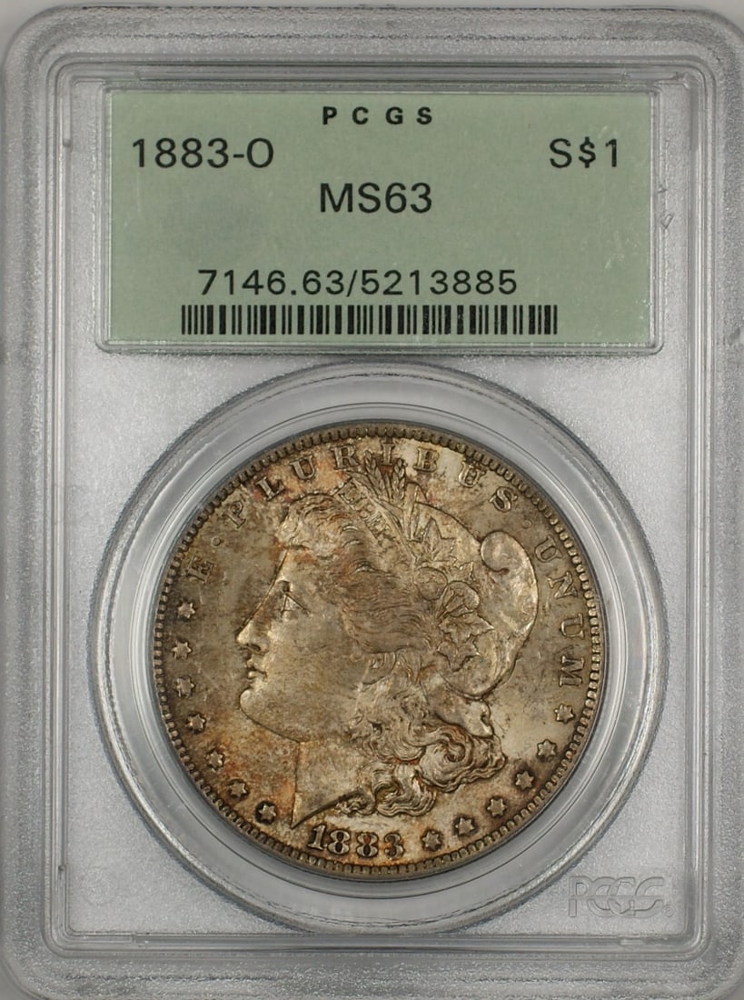 1883-O Morgan Silver Dollar PCGS MS63 Toned in Green Holder: 1883-O Morgan Silver Dollar PCGS MS63 Toned in Green Holder This 1883-O Morgan Silver Dollar is a stunning example of American coinage, certified by PCGS with a grade of MS 63. Displaying vibrant toni