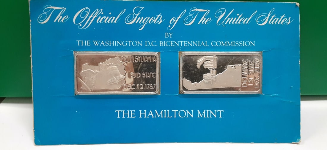 1976 Hamilton Mint Silver Ingots DE PA .999 Fine 1 Troy Oz Pair: 1976 Hamilton Mint Silver Ingots DE PA .999 Fine 1 Troy Oz Pair This offering features a pair of 1976 Hamilton Mint Statehood silver ingots, each composed of .999 fine silver and weighing 1 Troy Oz. T