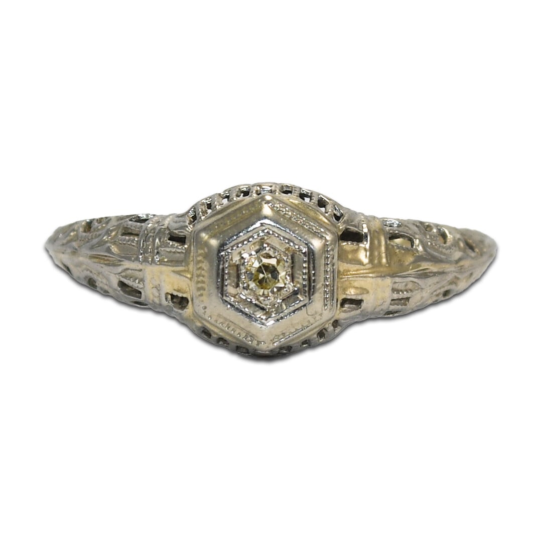 18K White Gold Art Deco Ladies Diamond Solitaire Ring: 18K White Gold Art Deco Ladies Diamond Solitaire Ring This stunning Art Deco diamond ring showcases a beautiful light yellow single cut diamond, elegantly set in 18K white gold. The ring features fanc