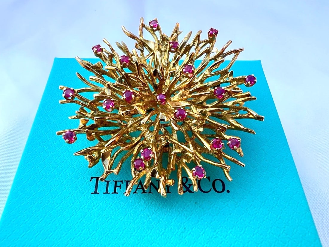 Tiffany & Co 18K Yellow Gold Ruby Brooch with Box and Bag: Tiffany & Co 18K Yellow Gold Ruby Brooch with Box and Bag This stunning brooch from Tiffany & Co. features exquisite craftsmanship in 18K yellow gold and is adorned with approximately 1.60 ct of vibra