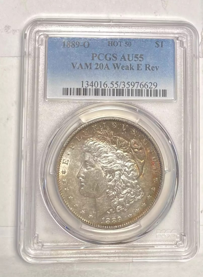 1889 O Morgan Silver Dollar PCGS AU 55 VAM 20A Weak E Reverse: 1889 O Morgan Silver Dollar PCGS AU 55 VAM 20A Weak E Reverse This 1889 O Morgan Silver Dollar, graded AU-55 by PCGS, showcases the exquisite craftsmanship of the New Orleans Mint. With a composition