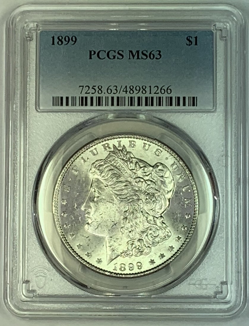1899 Morgan Silver Dollar Coin PCGS MS 63 Uncirculated: 1899 Morgan Silver Dollar Coin PCGS MS 63 Uncirculated This 1899 Morgan Silver Dollar Coin is a stunning piece of American numismatic history. With a denomination of $1, this uncirculated coin boasts