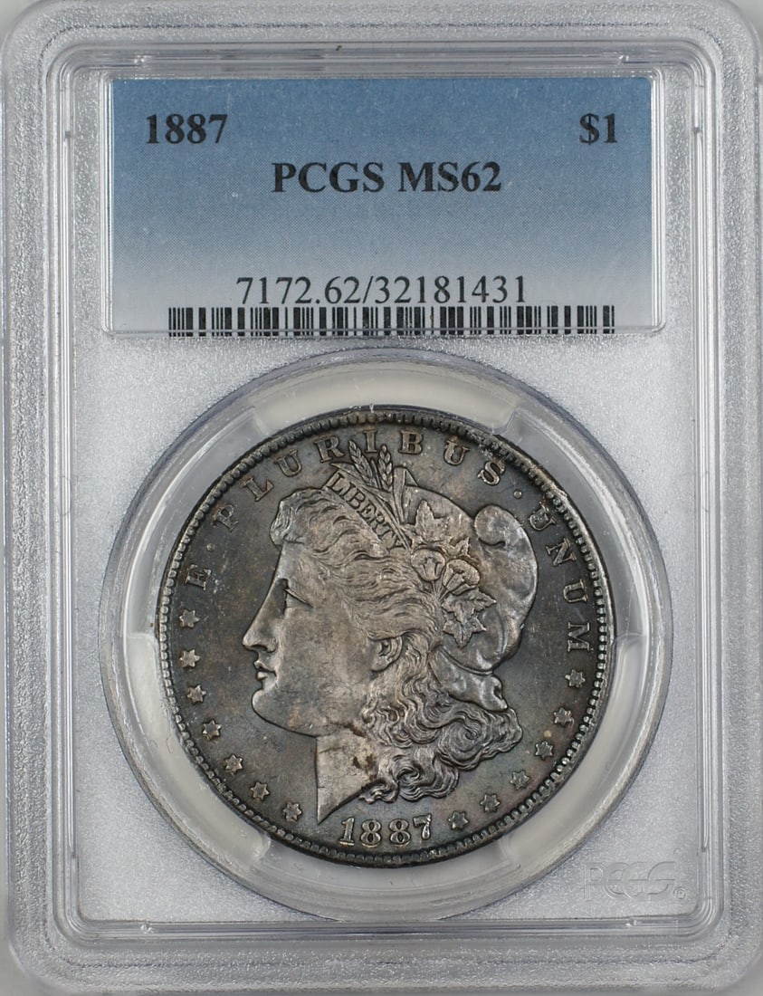 1887 Morgan Silver Dollar PCGS MS62 Toned Uncirculated Coin: 1887 Morgan Silver Dollar PCGS MS62 Toned Uncirculated Coin This 1887 Morgan Silver Dollar is a stunning example of American numismatic history. Certified by PCGS with a grade of MS 62, this uncircula