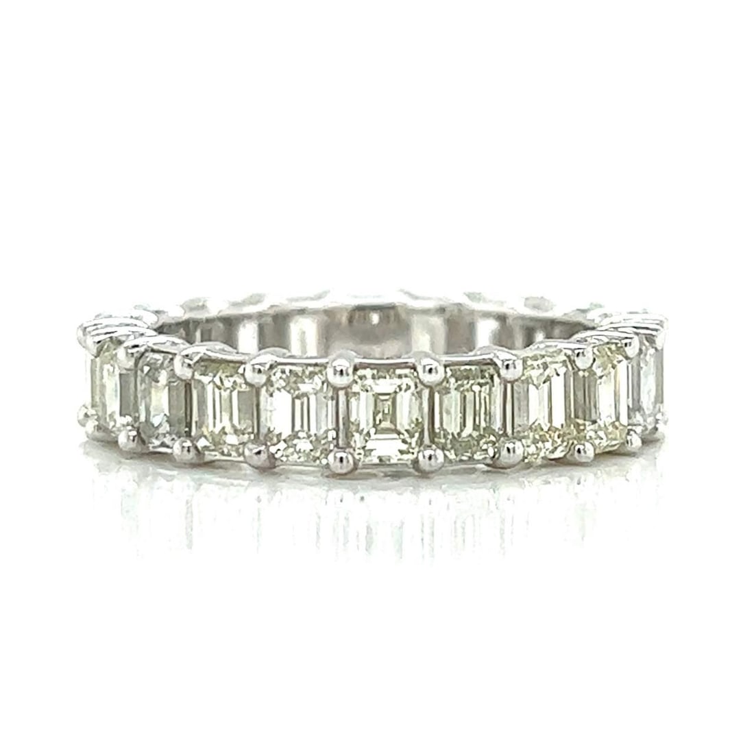 Platinum Emerald-cut Diamond Eternity Band 6.50 Ct 22 Diamonds: Platinum Emerald-cut Diamond Eternity Band 6.50 Ct 22 Diamonds This exquisite Platinum Eternity Band features 22 stunning Emerald-cut Diamonds, totaling approximately 6.50 Ct. The diamonds exhibit I-K