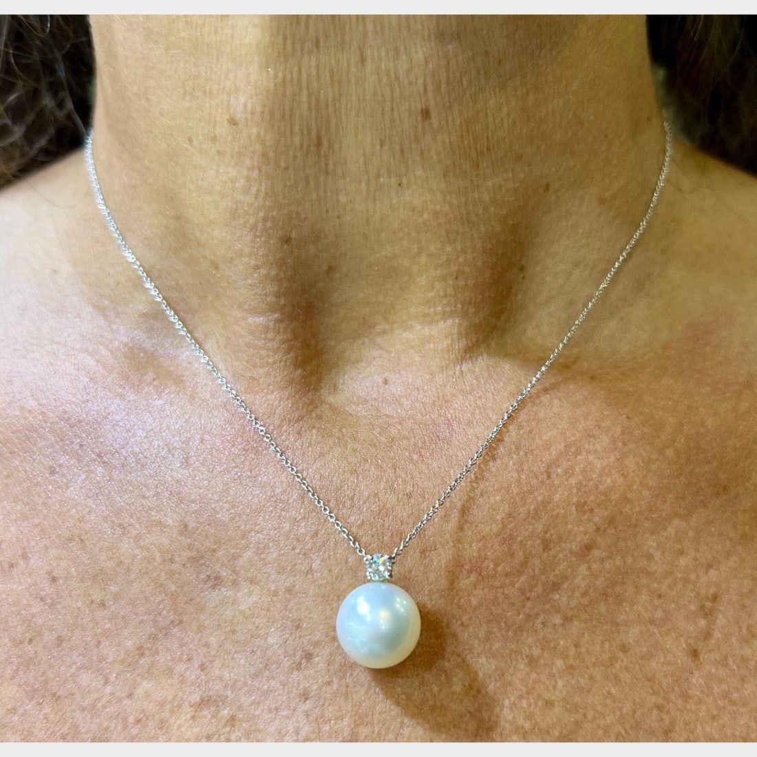 Tiffany & Co. Platinum 12mm Pearl Diamond Necklace: Tiffany & Co. Platinum 12mm Pearl Diamond Necklace This exquisite Tiffany & Co. necklace features a stunning 12.0mm South Sea pearl elegantly complemented by a 0.20 Ct. diamond. The diamond exhibits D