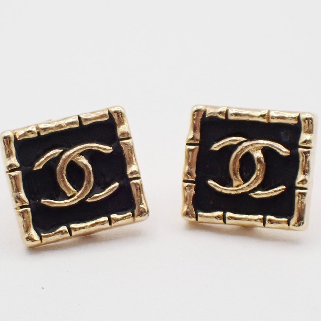 Vintage Chanel Gold Square CC Logo Stud Earrings Pair: Vintage Chanel Gold Square CC Logo Stud Earrings Pair This pair of vintage Chanel CC square stud earrings features a gold tone design. The earrings are in very good condition, with minor signs of wear