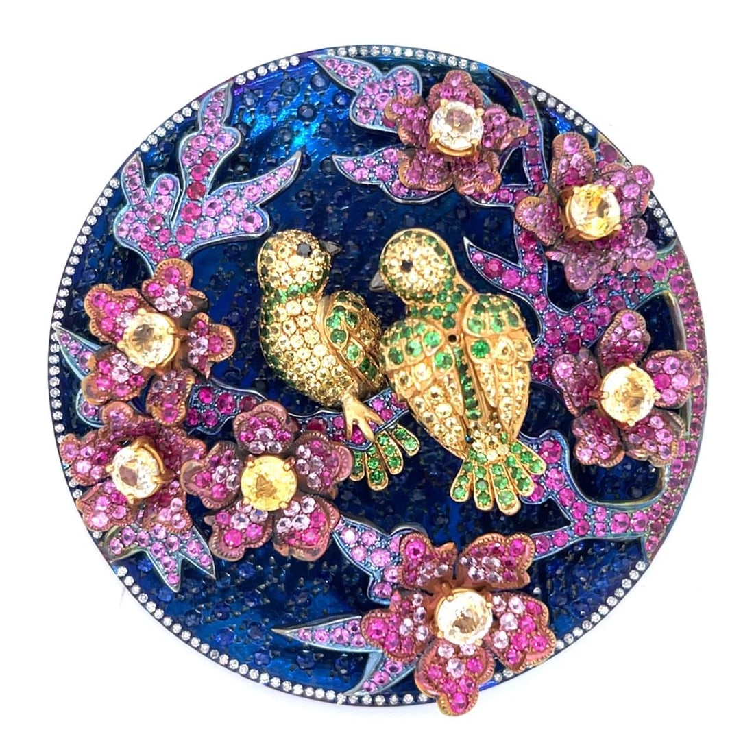 Sapphire and Diamond Brooch in Titanium and 18K Yellow Gold by NISAN: Sapphire and Diamond Brooch in Titanium and 18K Yellow Gold by NISAN This brooch features a striking combination of titanium and 18K yellow gold, adorned with approximately 30.00 carats of sapphires a