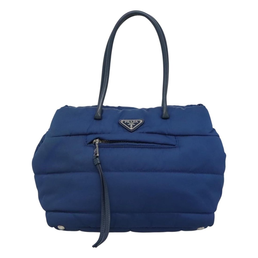 Blue Nylon Tote Prada Bomber Style Handbag: Blue Nylon Tote Prada Bomber Style Handbag This pre-owned Prada Bomber Tote in blue nylon offers both style and functionality. The handbag shows some signs of gentle use, including slight rubbing, min